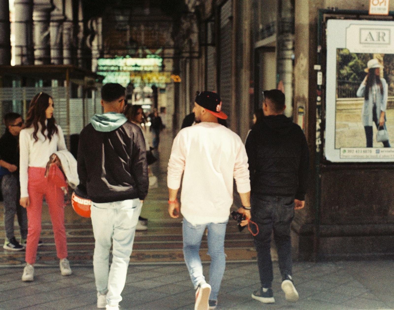 A Group of People Walking Down a Street
